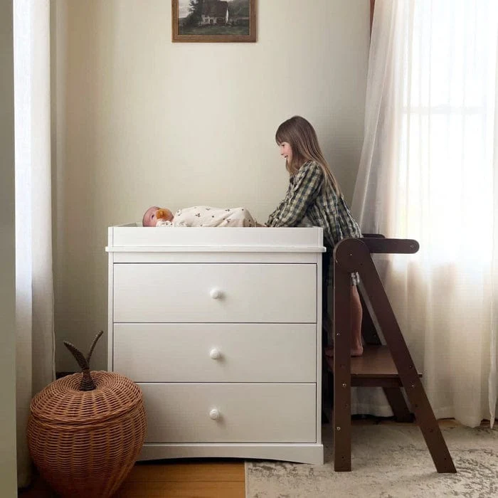 Walnut MILA learning tower in nursery beside white dresser - myduckling